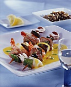 Seafood and ramsons (wild garlic) kebab on saffron sauce