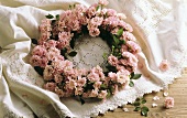 Wreath of pink roses on lace cover