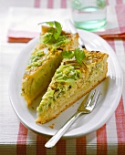 Two pieces of cheese and herb quiche with leeks