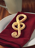 Clef (musical symbol) in pizza dough on napkin