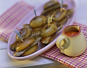 Barbecued potatoes with sausages on sticks