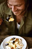 Man eating fruit salad