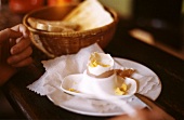 Breakfast egg, almost eaten; toast in bread basket
