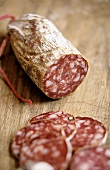 A hard cured sausage, slices cut