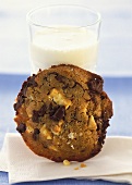 Chocolate chip cookie in front of a glass of milk