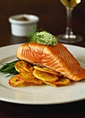 Salmon fillet with green olive cream on fried potatoes