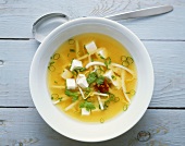 Miso soup with tofu, sprouts and herbs