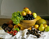 Assorted Fruits In and Around a Bowl