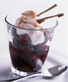 Cinnamon cherries with cream topping in a glass