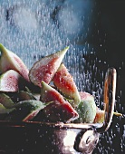 Sprinkling Sugar Over Sliced Figs