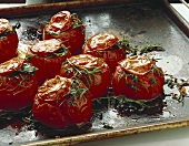 Stuffed beefsteak tomatoes on a baking tray