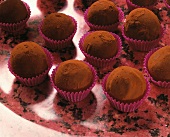 Brandy truffles sprinkled with cocoa in paper cases