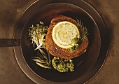 Fillet steak garnished with herbs and herb butter