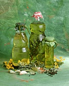 Drei Flaschen Sonnenblumenöl mit verschiedenen Kräutern