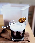 Espresso with foaming milk in a glass (Caffe macchiato)