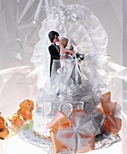 White wedding cake with bride and groom figures