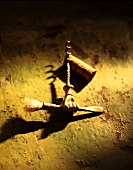 Bronze corkscrew in the shape of a hand with a paintbrush 