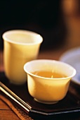 Chinese tea ceremony Gong Fu Cha: half-fermented tea in bowl, aroma cup behind