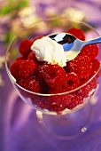Fresh raspberries with sugar and a spoonful of crème fraiche