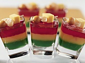 Jelly with skewered fruit in glasses