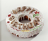 Ring cake with glace icing and 'Happy Birthday'