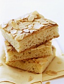 Three pieces of butter cake with flaked almonds