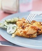 Potato tortilla with cheese, bacon and cucumber salad