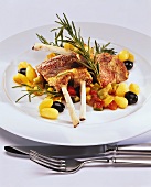 Rack of lamb on ratatouille with potatoes, olives, rosemary