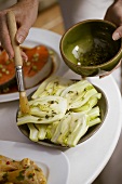 Brushing fennel with herb marinade
