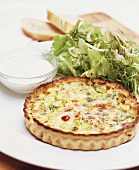 Quiche lorraine with salad and cream dressing