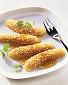 Fried bananas with sesame in honey sauce