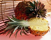 Baby pineapple, (Ananas comosus), halved