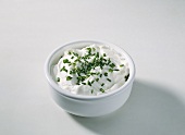 Quark with chives in small white bowl
