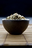 Long-grain rice with wild rice in brown bowl