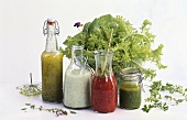 Four different salad dressings in front of salad bowl