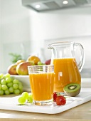 Multivitamin juice in glass and jug