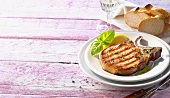 Grilled pork chop with basil and white bread