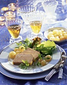 Goose liver terrine, garnished with salad and pearl onions