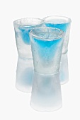 Three ice glasses with blue schnapps