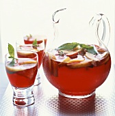 Sangria (red wine punch, Spain) in glass jug and glasses