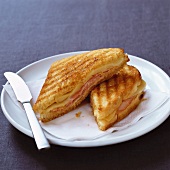 Toasted ham and cheese sandwich, halved