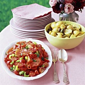 Tomato salad and potatoes with capers on buffet table