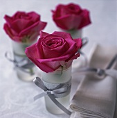 Table decoration of red roses in glasses