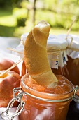 Nectarine jam with croissant on table in the open air