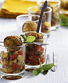 Meatballs on tomato and cucumber salad in glasses