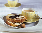 Two slices of bread plait with poppy seed filling, coffee