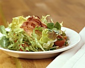 Salad leaves with sheep's cheese wrapped in bacon