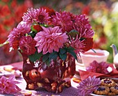 Pink dahlias in vase with apple motif