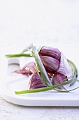 Garlic on white chopping board