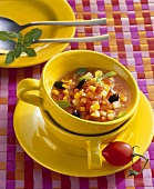 Pumpkin soup with tomatoes and olives